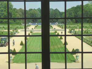 Looking through a window at Charlottenburg Palace in Berlin out into the formal palace gardens